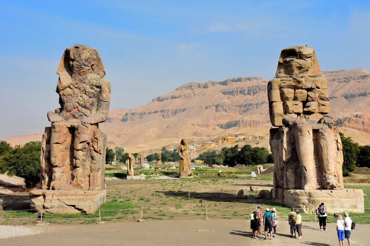 The Colossi of Memnon, the two seated statues of Amenhotep III by the West Bank road, seen on a Valley of the Kings tour